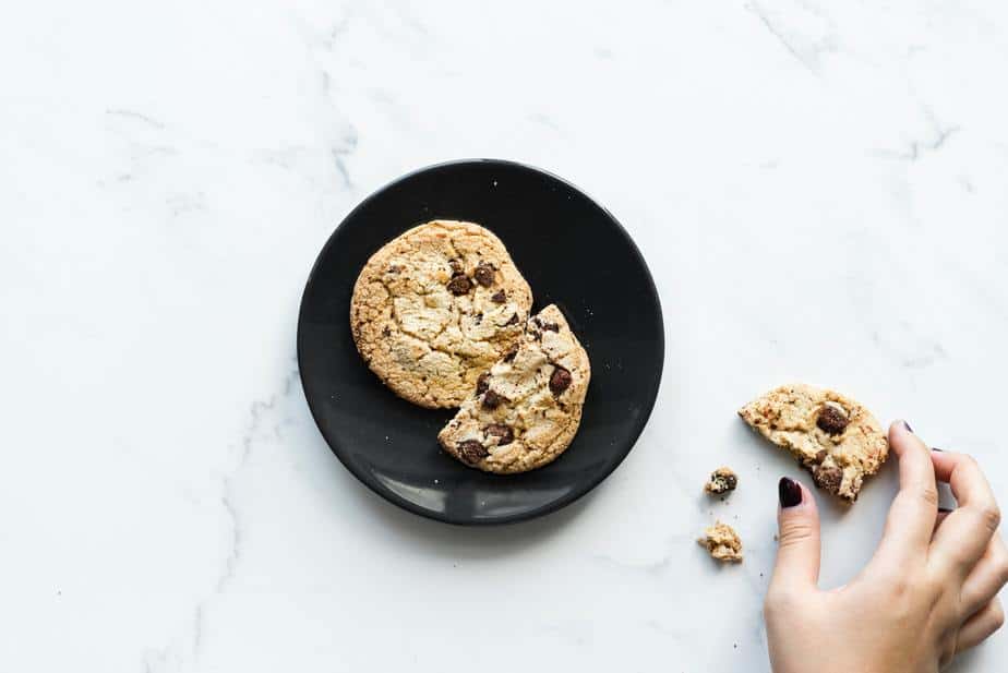 chocolate-chip-cookie-hand-breaking-a-piece