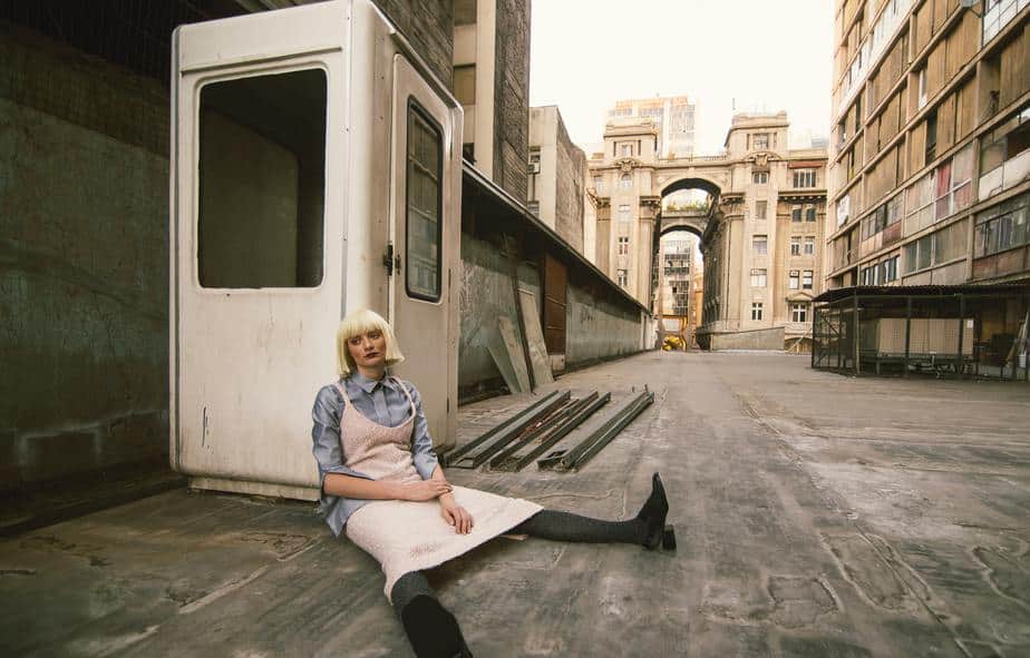 young-woman-sitting-street-alley