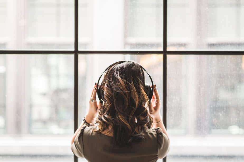 young-woman-with-headphones-wide-window