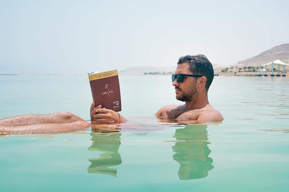 leisure-man-sunglasses-reading-pool