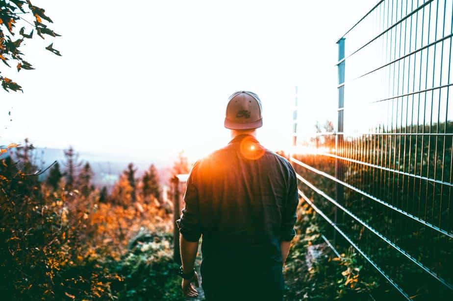 young-man-walking-sunset-horizon