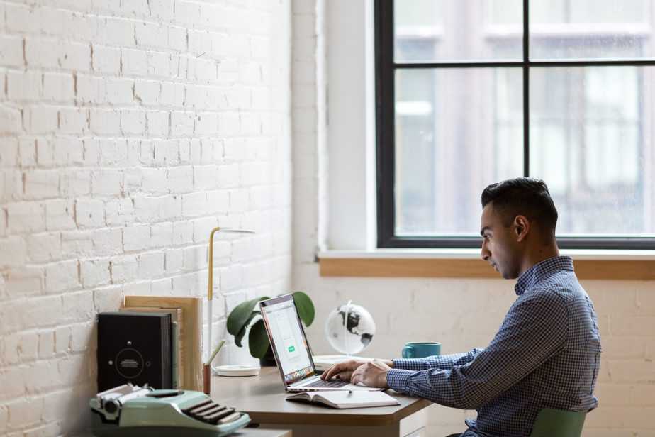 man-sitting-down-to-write-content-for-small-biz